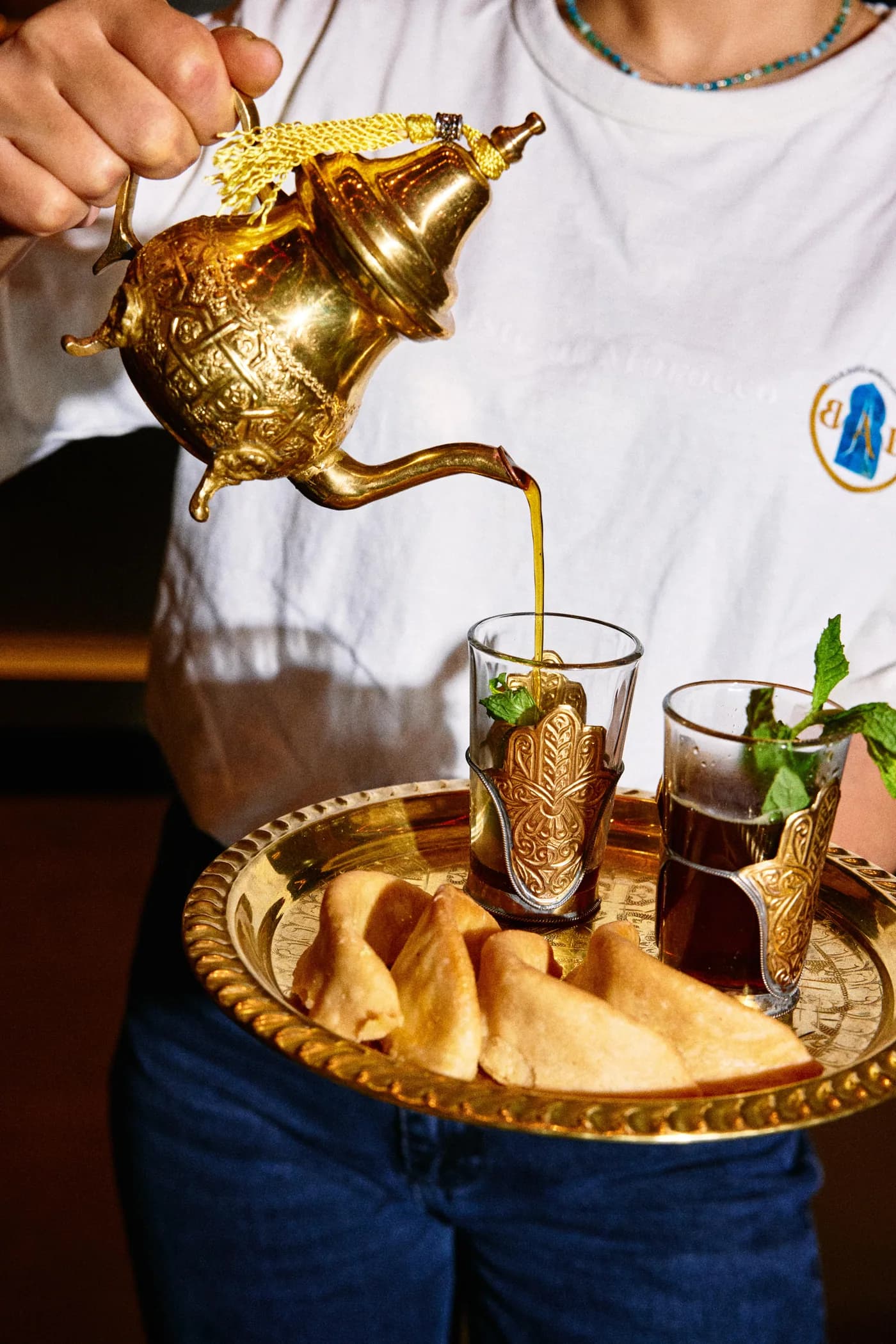 Moroccan mint tea served on a brass tray with pastries